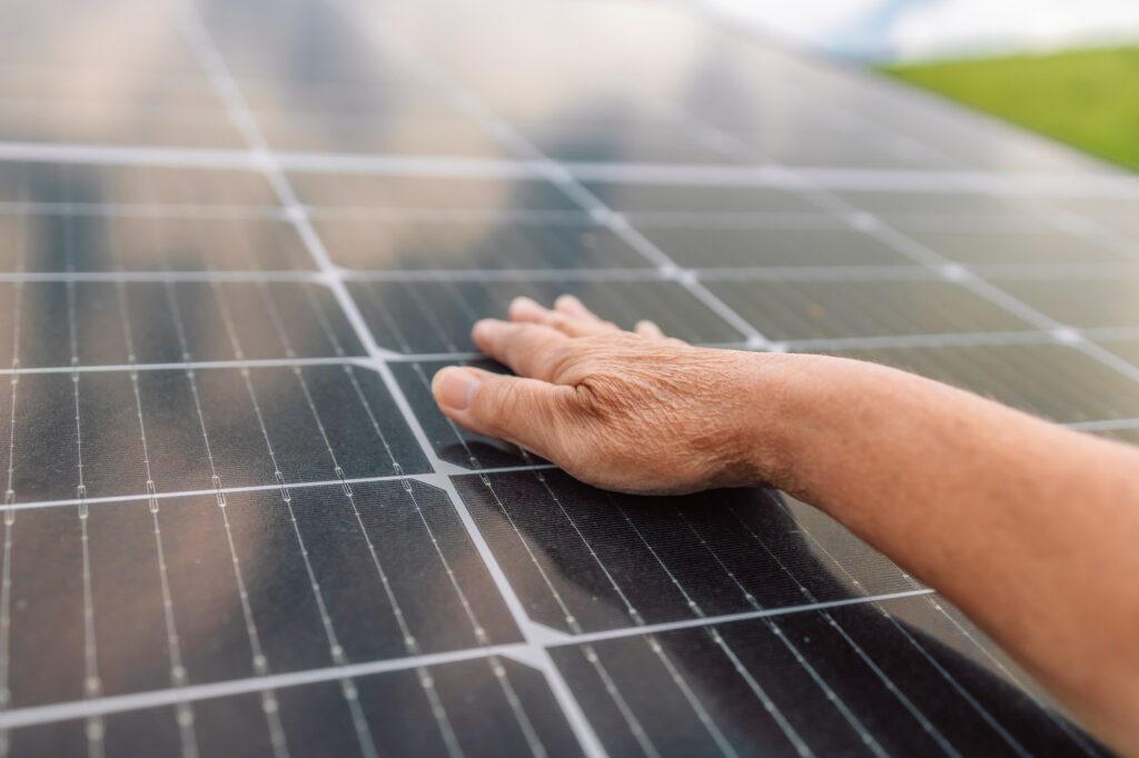 female hand touching stroking photovoltaic solar panels